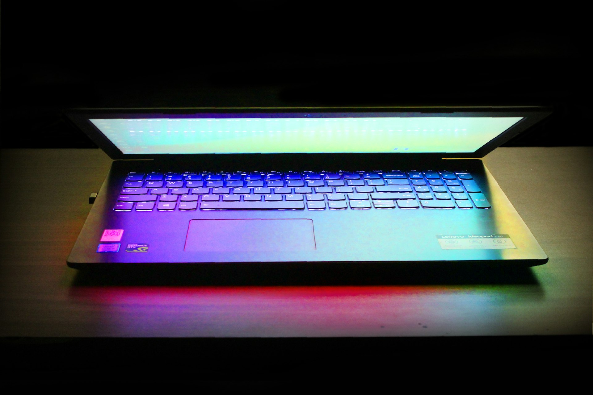 a laptop computer sitting on top of a wooden table